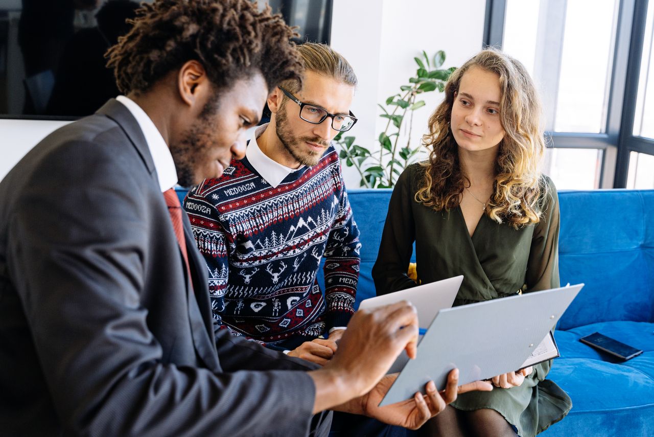 Crafting Captivating Headlines: Your awesome post title goes here A diverse group of young professionals engaged in a business meeting inside a modern office.